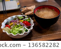 A bowl of salad with miso soup in a black cup, Japanese food. on the wooden table 136582282