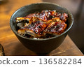 Unagi don. Grilled eel with sweet sauce rice bowl on wooden table. 136582284