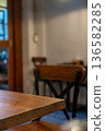 Seating inside the cafe or restaurant, with wooden chairs and table 136582285