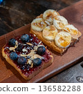 Bread topped with jam, blueberry and fresh banana slices 136582288