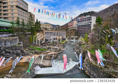Many carp streamers swimming in the valley of Jozankei Onsen, Hokkaido's Boys' Festival 136583426