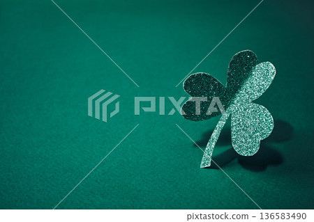 Glittering shamrock standing on green background representing good luck Glittering shamrock standing on green background representing good luck 136583490