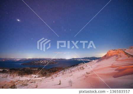 A starry sky and winter galaxy spread across the snowy fields of Bihoro Pass A starry sky and winter galaxy spread across the snowy fields of Bihoro Pass 136583557