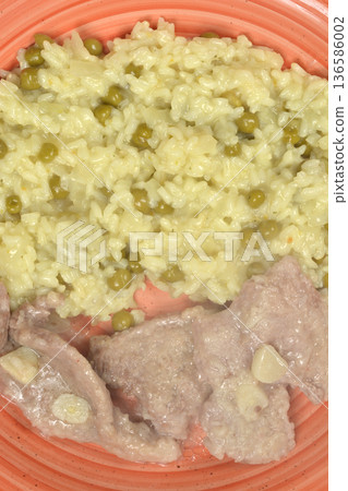 Pork medallions and risotto with peas on a plate Pork medallions and risotto with peas on a plate 136586002
