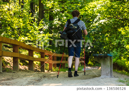 Young man alone in woodland. 136586526