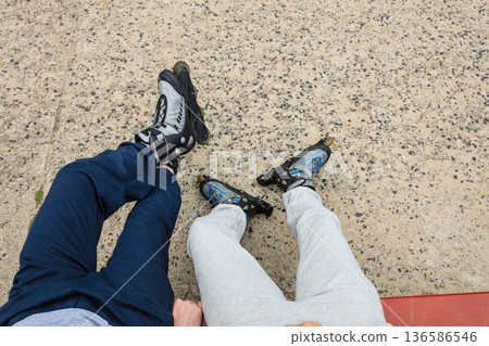 Closeup of people friends with roller skates. Closeup of people friends with roller skates. 136586546