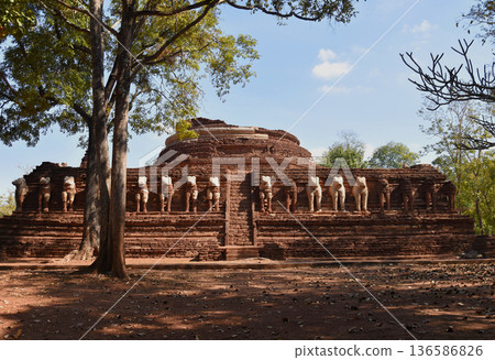 Ancient ruins Buddhist pagoda is decorated with elephant statues all around. 136586826