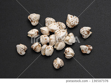 Puffed buckwheat pile isolated on black background, cereal breakfast grains, top view, full depth of field 136587376
