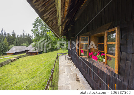 Traditional Slovak wooden house with flowers in Zuberec Traditional Slovak wooden house with flowers in Zuberec 136587563