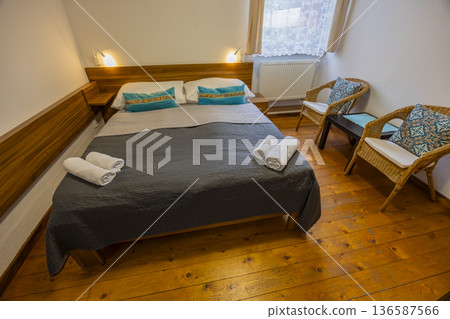 Bedroom interior with double bed offering comfort and relaxation Bedroom interior with double bed offering comfort and relaxation 136587566