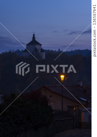 Old Castle Banska Stiavnica at night with glowing street lamp 136587641