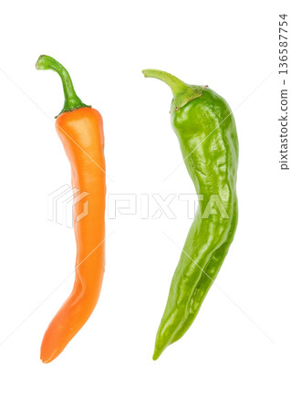 Fresh orange and green chili peppers isolated on white background. 136587754
