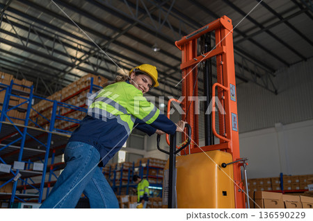 Warehouse worker working in warehouse storage.  136590229
