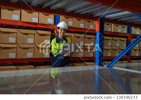 Warehouse worker working in warehouse storage. Warehouse worker working in warehouse storage. 136590233