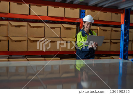 Warehouse worker working in warehouse storage.  136590235
