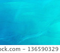 Beautiful blue calm surface of the sea under soft natural daylight, featuring gentle ripples and a serene horizon. The tranquil ocean water creates a peaceful background with a minimalistic, relaxing 136590329