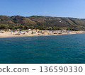 Beautiful panoramic view of the Calabrian coast during the summer season, featuring turquoise crystal-clear waters, dramatic rocky cliffs, and charming seaside scenery under bright blue skies. The 136590330
