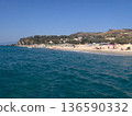 Beautiful panoramic view of the Calabrian coast during the summer season, featuring turquoise crystal-clear waters, dramatic rocky cliffs, and charming seaside scenery under bright blue skies. The 136590332