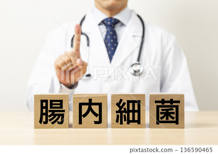 A block with the word "intestinal bacteria" written on it and a doctor 136590465