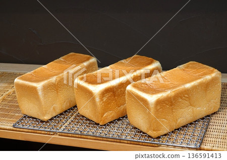 Freshly baked bread Three loaves of white bread lined up 136591413