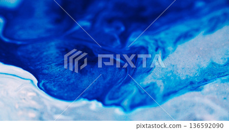 Acrylic blend. Pigment spread. Blue sparkling dye leak on white abstract background. Shimmering liquid ink wave color blur texture. 136592090