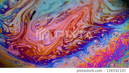 Defocused iridescent soap. Colorful ink wave. Curve neon spectrum liquid splash abstract background. Blue purple orange art gasoline blend. 136592105