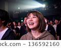 A woman who seems to be having fun at a live concert 136592160