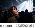 A woman who seems to be having fun at a live concert 136592161