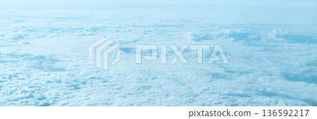 Expansive aerial view of cloudy sky and atmosphere from above with soft blue 136592217