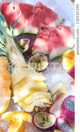 A tasty fruit salad on top of clear ice 136592399