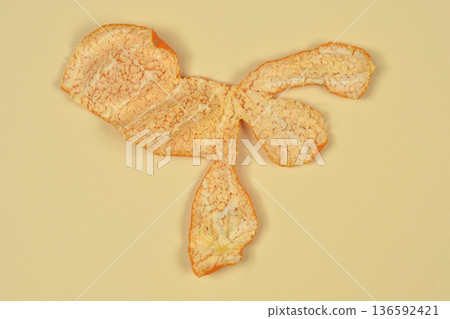 Mandarin peel pith on a yellow background Mandarin peel pith on a yellow background 136592421