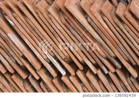 Stack of old terracotta roof tiles 136592439