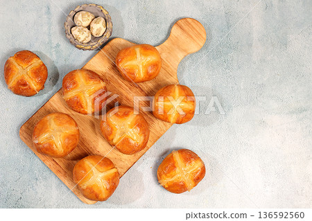 Happy Easter concept. Easter buns with a cross on a concrete table . English buns are baked on Friday and served with tea the morning before Easter Sunday. A festive Easter treat, 136592560