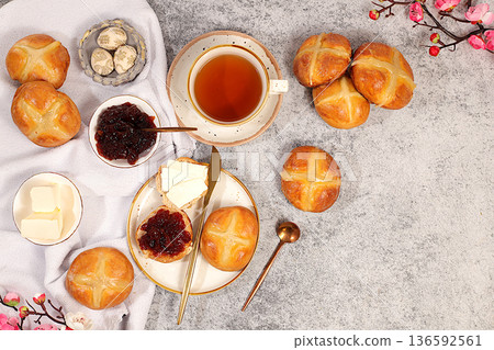 Festive Easter treat. Easter buns are decorated with a cross, jam, butter, and cherry blossoms. English buns are baked on Friday and served with tea the morning before Easter Sunday. 136592561