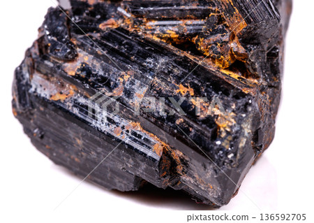 macro mineral stone sherle, schorl, black tourmaline on white background 136592705