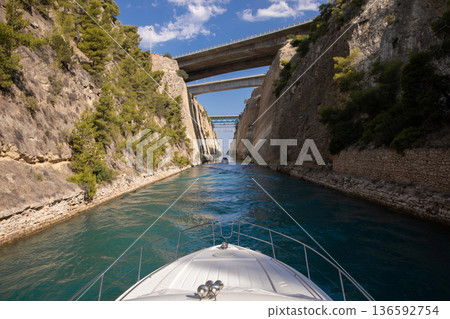 Passing through the Corinth Canal by yacht from the Saronic Gulf in the Aegean Sea to the Gulf of Corinth in the Ionian Sea, Greece. Horizontal. 136592754