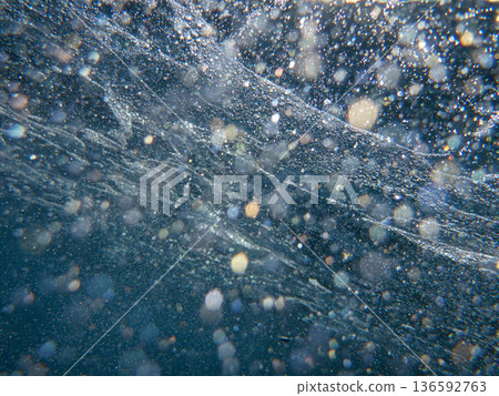 Air bubbles under the sea surface off the coast of Meganisi island in the Ionian Sea, Greece. Air bubbles under the sea surface off the coast of Meganisi island in the Ionian Sea, Greece. 136592763
