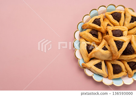 Purim celebration concept, jewish carnival holiday. Hamantaschen cookies over white neutral rose background 136593000