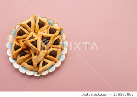 Purim celebration concept, jewish carnival holiday. Hamantaschen cookies over white neutral rose background 136593002