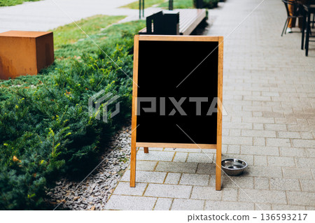Restaurant sidewalk chalkboard sign board. Old Black Signboard on the city street. Blank store signage sign design mockup isolated Restaurant sidewalk chalkboard sign board. Old Black Signboard on the city street. Blank store signage sign design mockup isolated 136593217
