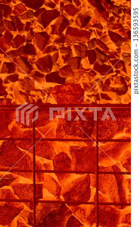 Pattern of burning ore stones in smelting furnace separated with iron mesh. Burning ore in blast furnace illustrative image for vertical story 136593595