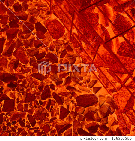 Textured image of red hot pieces of ore bearing rocks in furnace. Photo that illustrates the process of smelting metals from ore 136593596