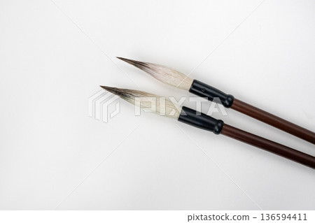 Two writing brushes, pens for writing Chinese traditional calligraphy. Traditional writing brushes isolated on white background 136594411