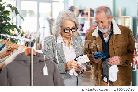 man and a woman choose a set of socks together man and a woman choose a set of socks together 136596786