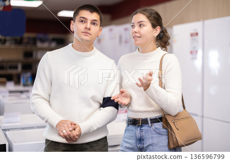 Young couple choosing washing machine or dishwasher 136596799