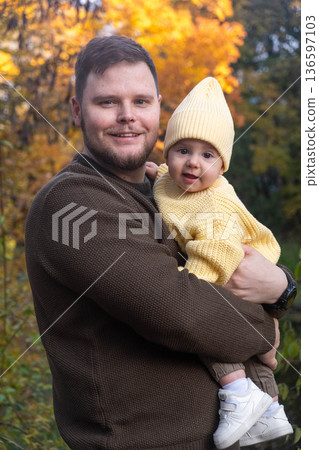 Father and Baby Enjoying Autumn Sunlight 136597103