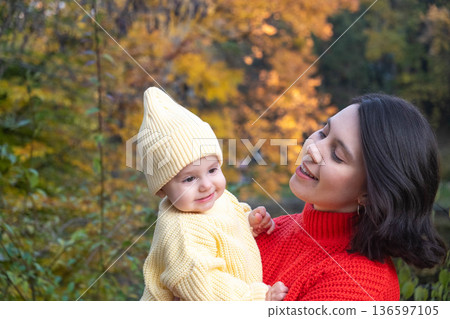 Mother and Baby Smiling in Autumn Park 136597105