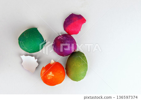 Colorful cracked easter egg shells on white background with copy space. Soft focus 136597374