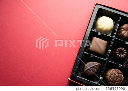 Chocolate candies on a red background 136597990
