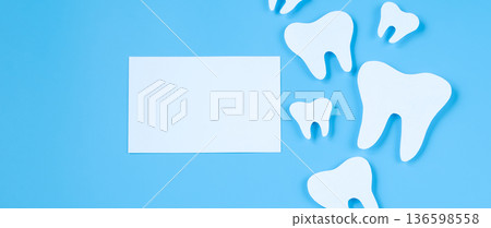 Paper cut mockup of tooth on blue background. Dental care concept. International Dentist Day. Paper cut mockup of tooth on blue background. Dental care concept. International Dentist Day. 136598558